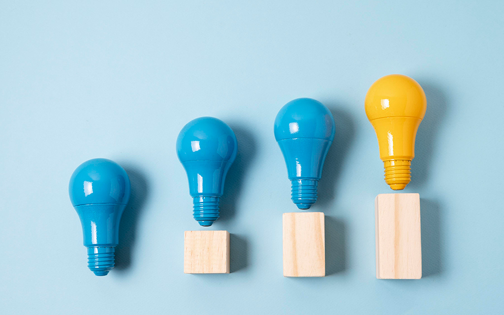 Lightbulbs over a bar chart that increases, ending in a lighted bulb, which represents that progressive work following recommendations ends up successfully. 